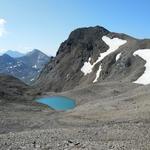 über Schutt laufen wir abwärts zu einer kleinen Ebene mit Bergsee