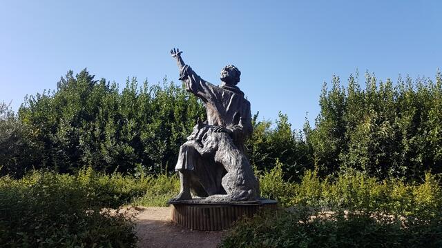 vor der Kirche ist in einer Bronzestatue die Episode mit dem Wolf und San Francesco dargestellt